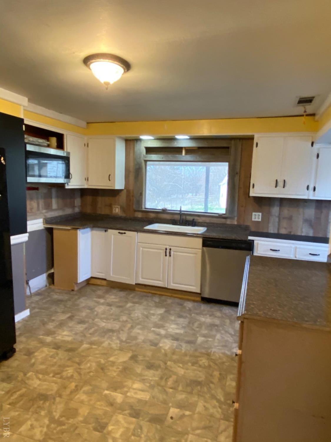3211 Leesville Road Lynch Station, VA 24571 - Photo 20 of 22 a kitchen with granite countertop a sink a stove and cabinets