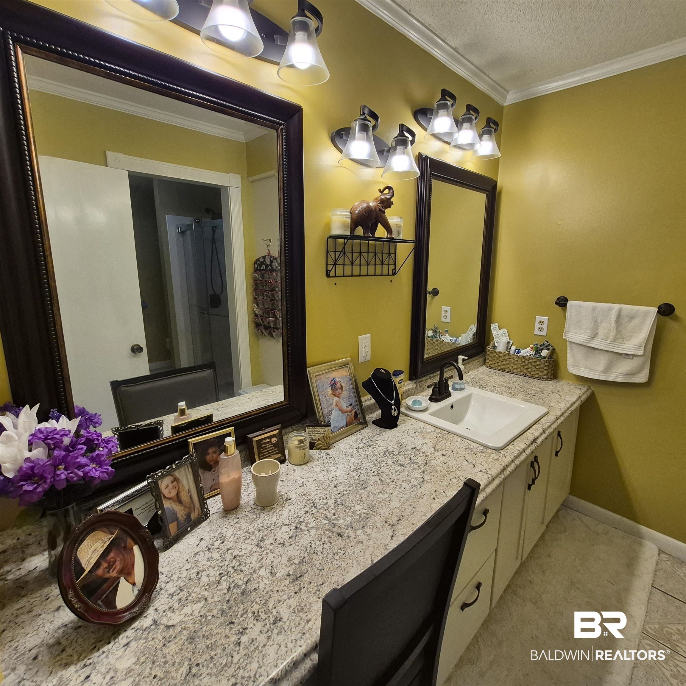 26635 Highway 41 Range, AL 36473 - Photo 25 of 74 Bathroom with ornamental molding, vanity, a textured ceiling, a shower with curtain, and light tile patterned floors