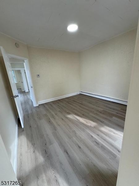 10 Riverside Place Garfield, NJ 07026 - Photo 13 of 26 a view of an empty room with wooden floor and stairs