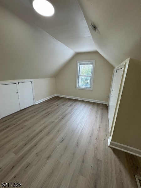 10 Riverside Place Garfield, NJ 07026 - Photo 19 of 26 an empty room with wooden floor and windows