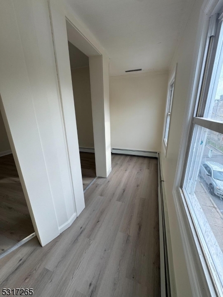10 Riverside Place Garfield, NJ 07026 - Photo 10 of 26 a view of a hallway view with wooden floor