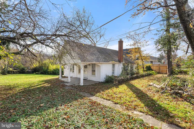 a view of a house with a yard covered with snow