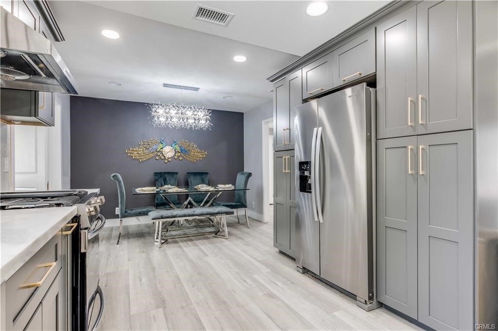 10664 Morning Glory Avenue Fountain Valley, CA 92708 - Photo 13 of 31 a kitchen with stainless steel appliances a refrigerator and a stove