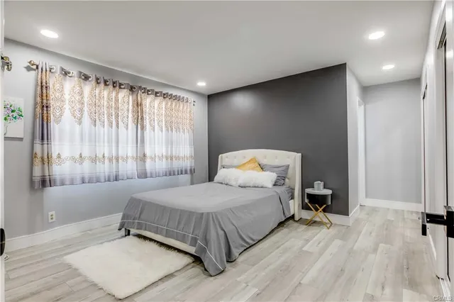 a bedroom with a bed and a large window