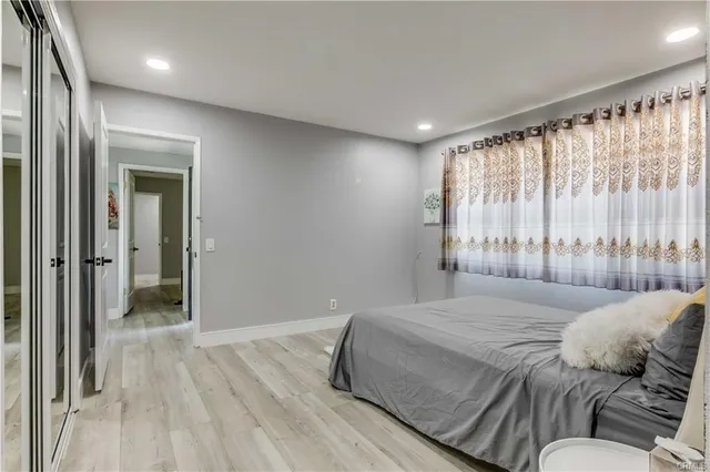 a bedroom with a large bed and a large window