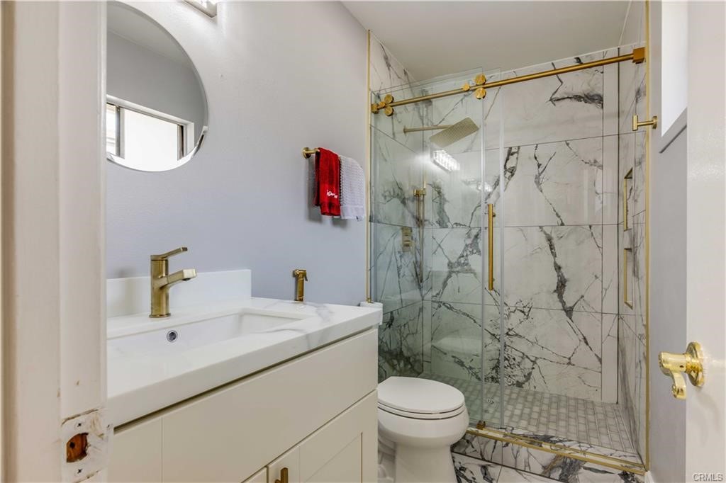 10664 Morning Glory Avenue Fountain Valley, CA 92708 - Photo 19 of 31 a bathroom with a sink toilet and shower