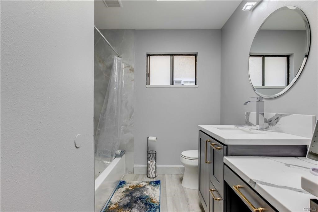 10664 Morning Glory Avenue Fountain Valley, CA 92708 - Photo 23 of 31 a bathroom with a sink toilet and a mirror