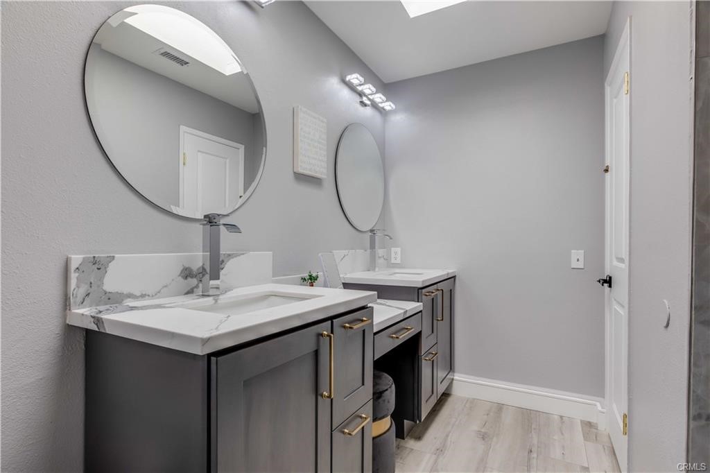10664 Morning Glory Avenue Fountain Valley, CA 92708 - Photo 24 of 31 a bathroom with a sink and a mirror