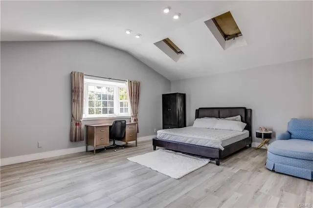 a spacious bedroom with a bed and a window