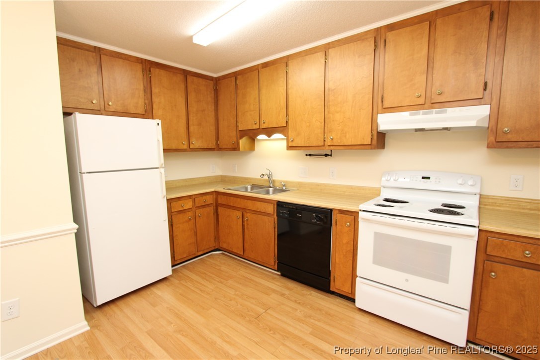 6124 Deerwood Place Raleigh, NC 27607 - Photo 11 of 22 a kitchen with a refrigerator sink and cabinets