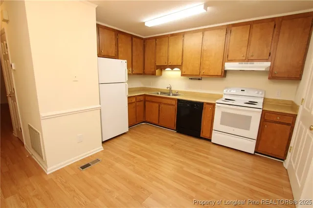 a kitchen with stainless steel appliances granite countertop a refrigerator sink and cabinets