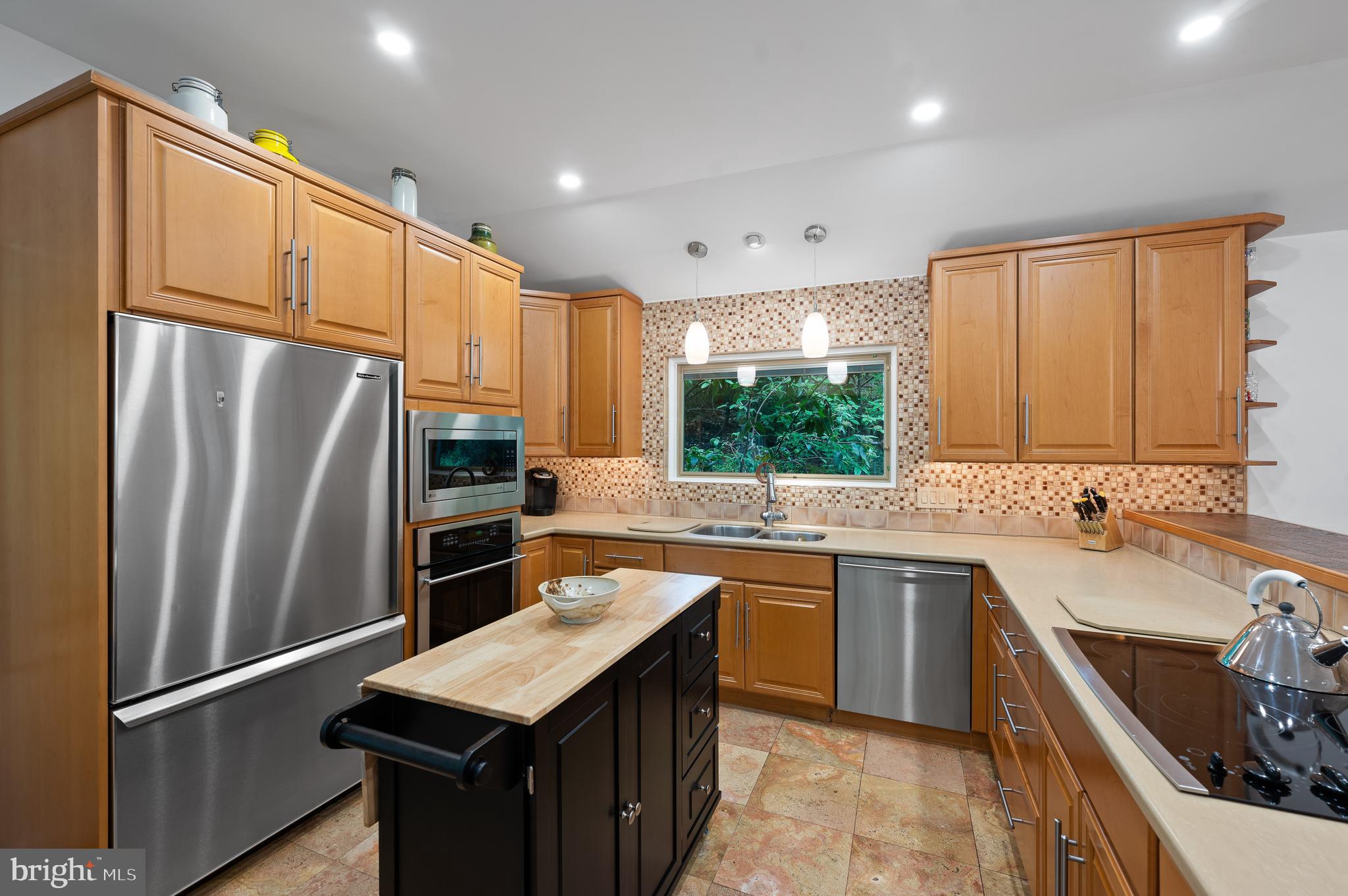 590 Fletcher Road Wayne, PA 19087 - Photo 14 of 44 a kitchen with stainless steel appliances granite countertop a sink stove refrigerator and cabinets