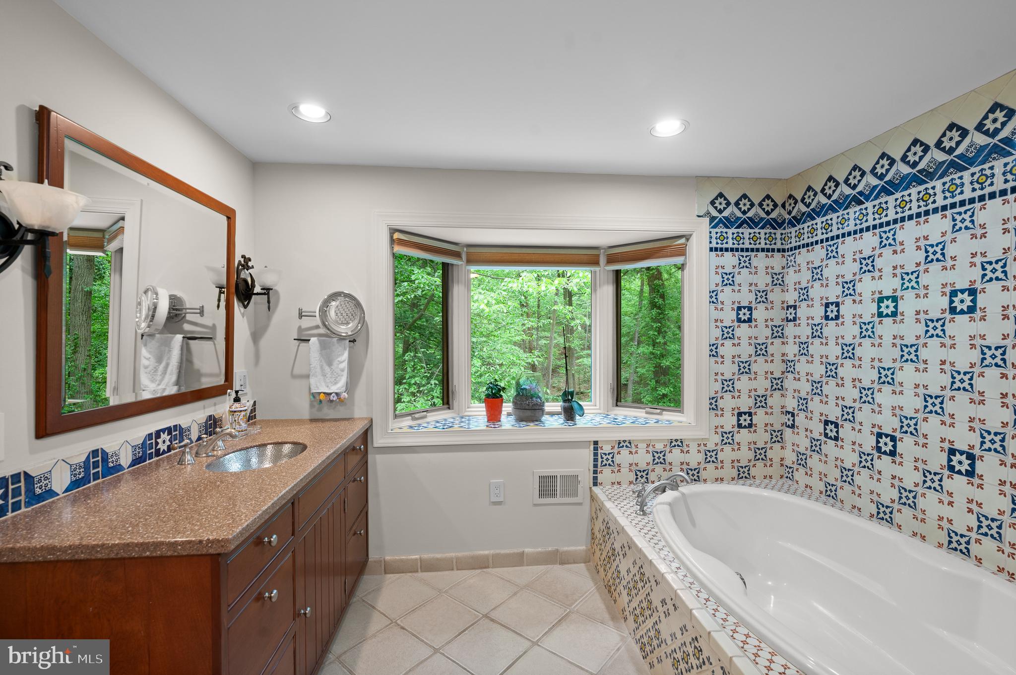 590 Fletcher Road Wayne, PA 19087 - Photo 24 of 44 a bathroom with a bathtub sink mirror vanity and a toilet