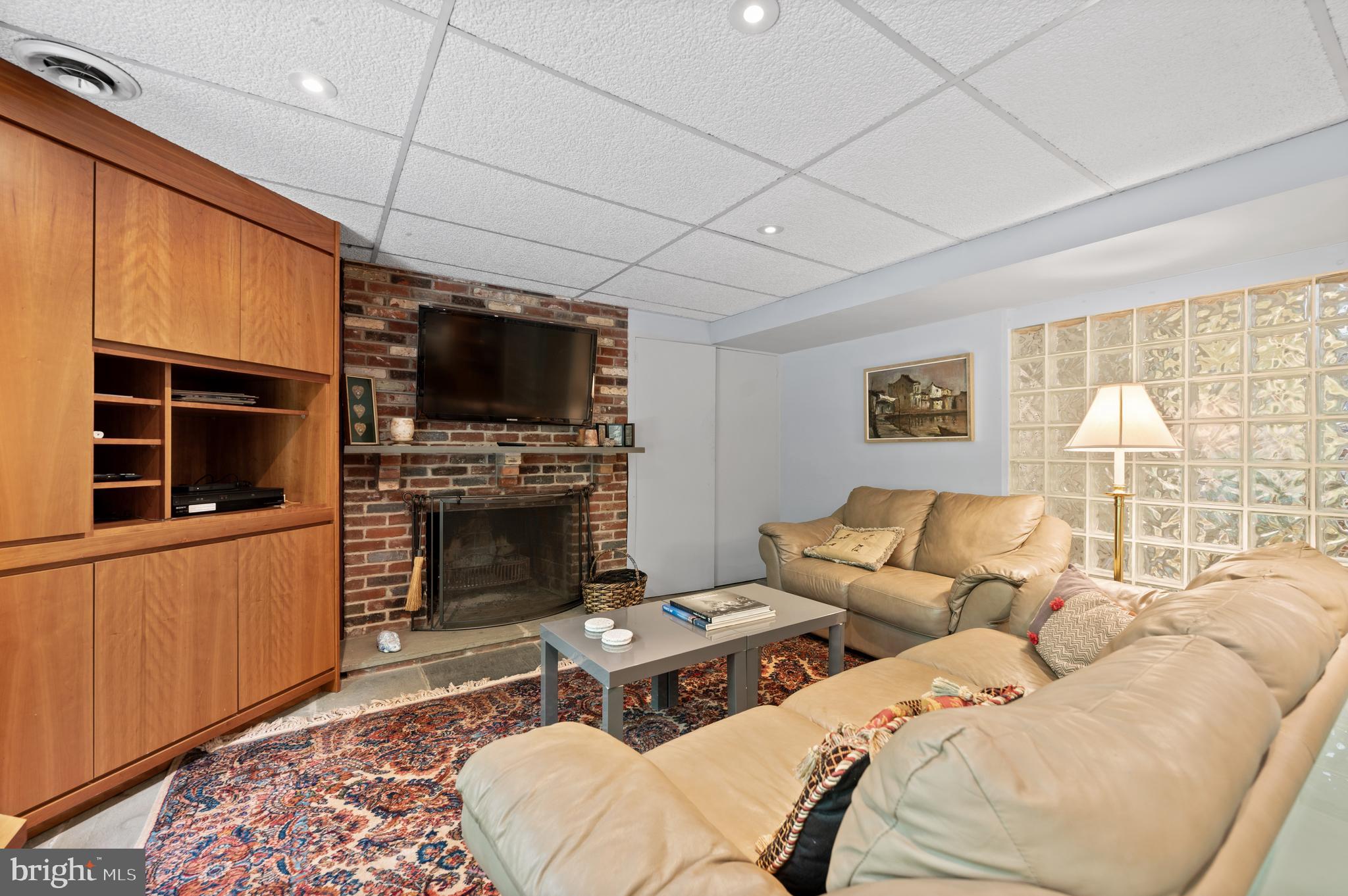 590 Fletcher Road Wayne, PA 19087 - Photo 29 of 44 a living room with furniture a flat screen tv and a fireplace