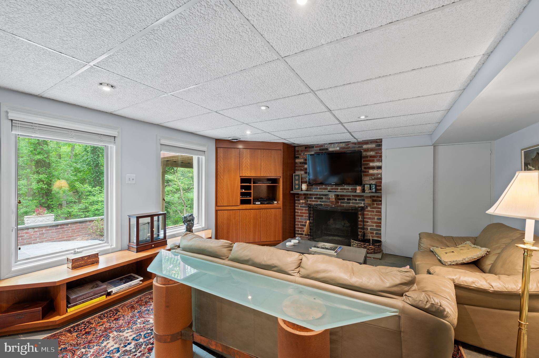 590 Fletcher Road Wayne, PA 19087 - Photo 31 of 44 a living room with a fireplace furniture a flat screen tv and a faucet