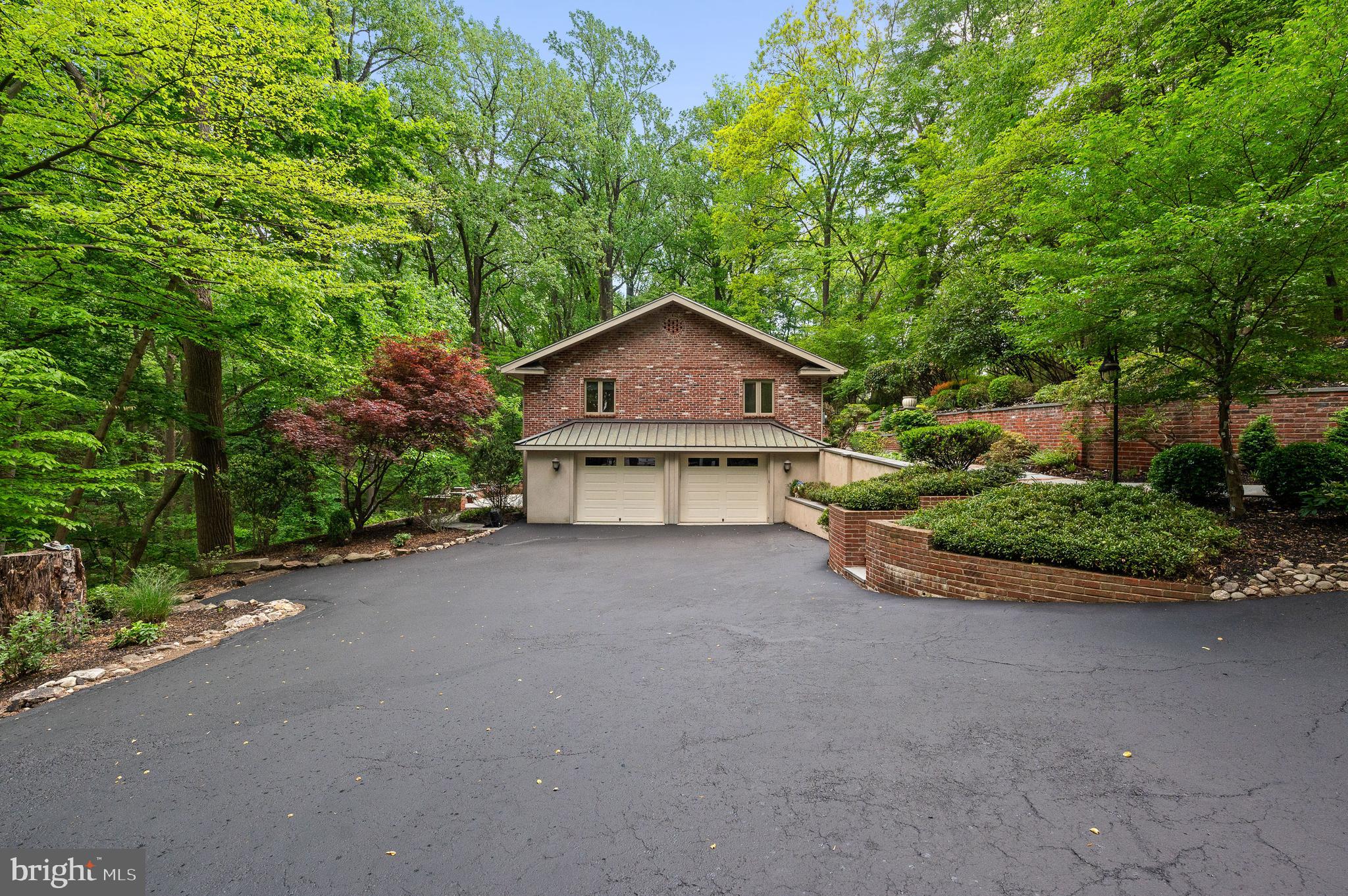 590 Fletcher Road Wayne, PA 19087 - Photo 40 of 44 a front view of a house with a yard and garage