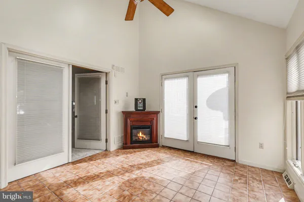 an empty room with closet and windows