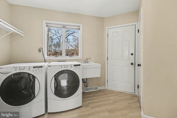 a view of a hallway with washer and dryer