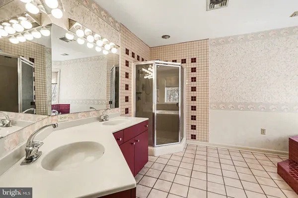 a spacious bathroom with a sink a vanity and a mirror