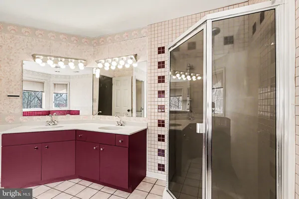 a spacious bathroom with a granite countertop sink mirror and shower