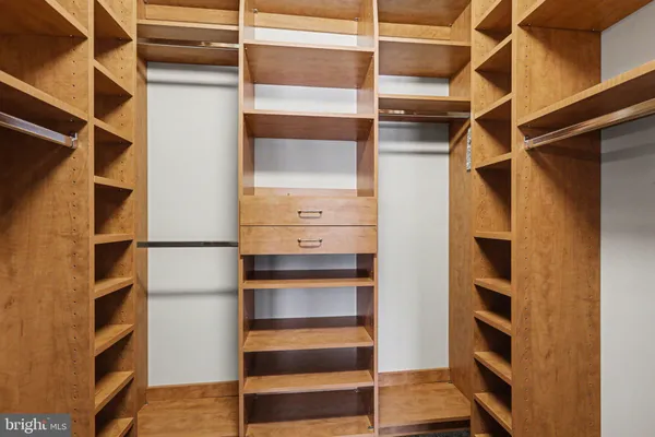a view of walk in closet with empty racks