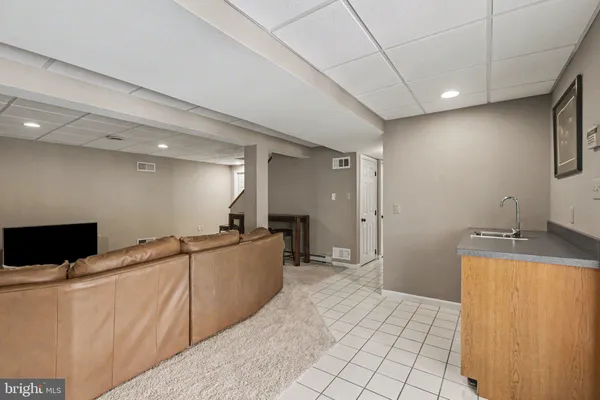 a kitchen with stainless steel appliances a sink a stove top oven a counter space and cabinets