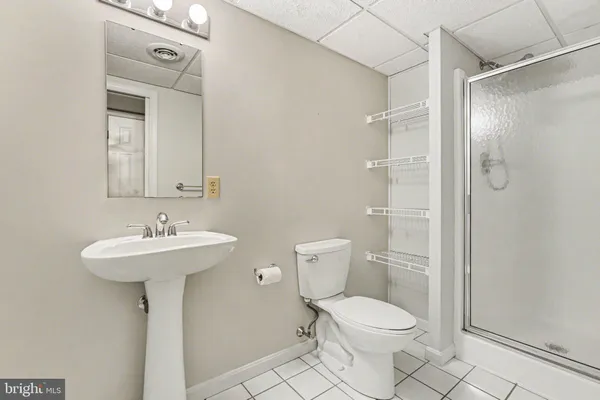 a bathroom with a toilet sink shower and mirror