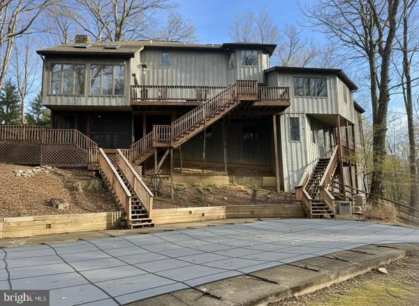 a view of a house with wooden fence