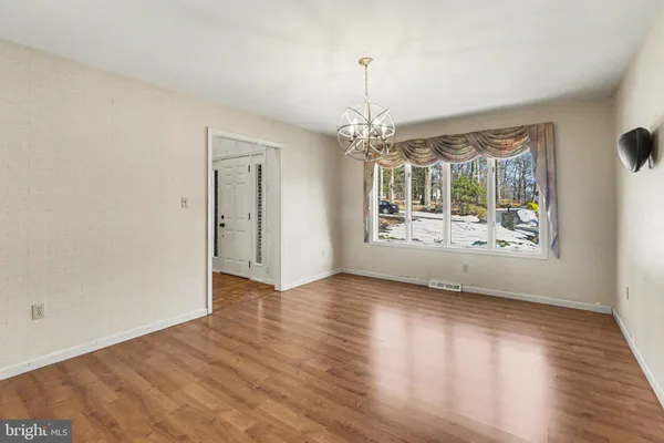a view of a room window and wooden floor