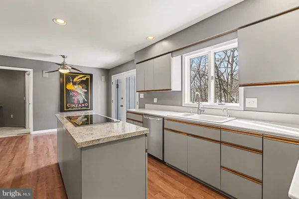 a kitchen with stainless steel appliances granite countertop a sink and dishwasher with wooden cabinets