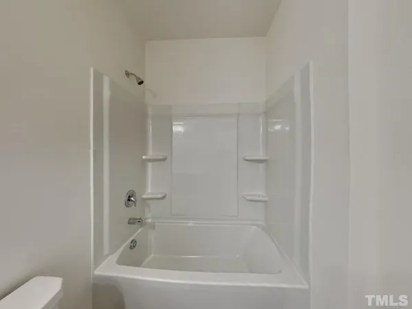 a bathroom with a bathtub and toilet