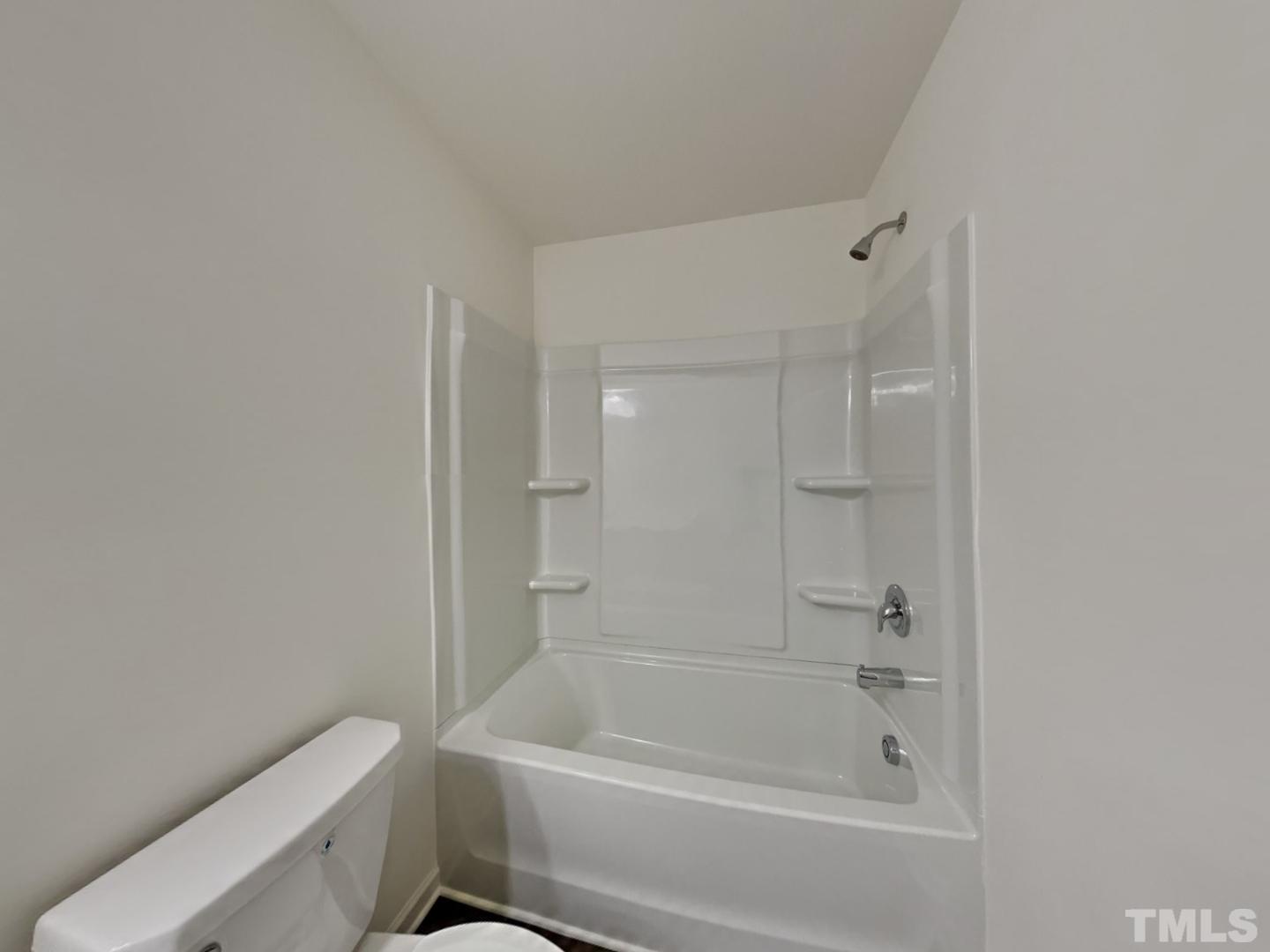 117 Mdw Vista Lane Angier, NC 27501 - Photo 14 of 18 a bathroom with a bathtub and toilet