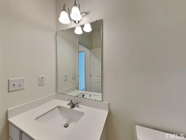 a bathroom with a sink vanity and a mirror