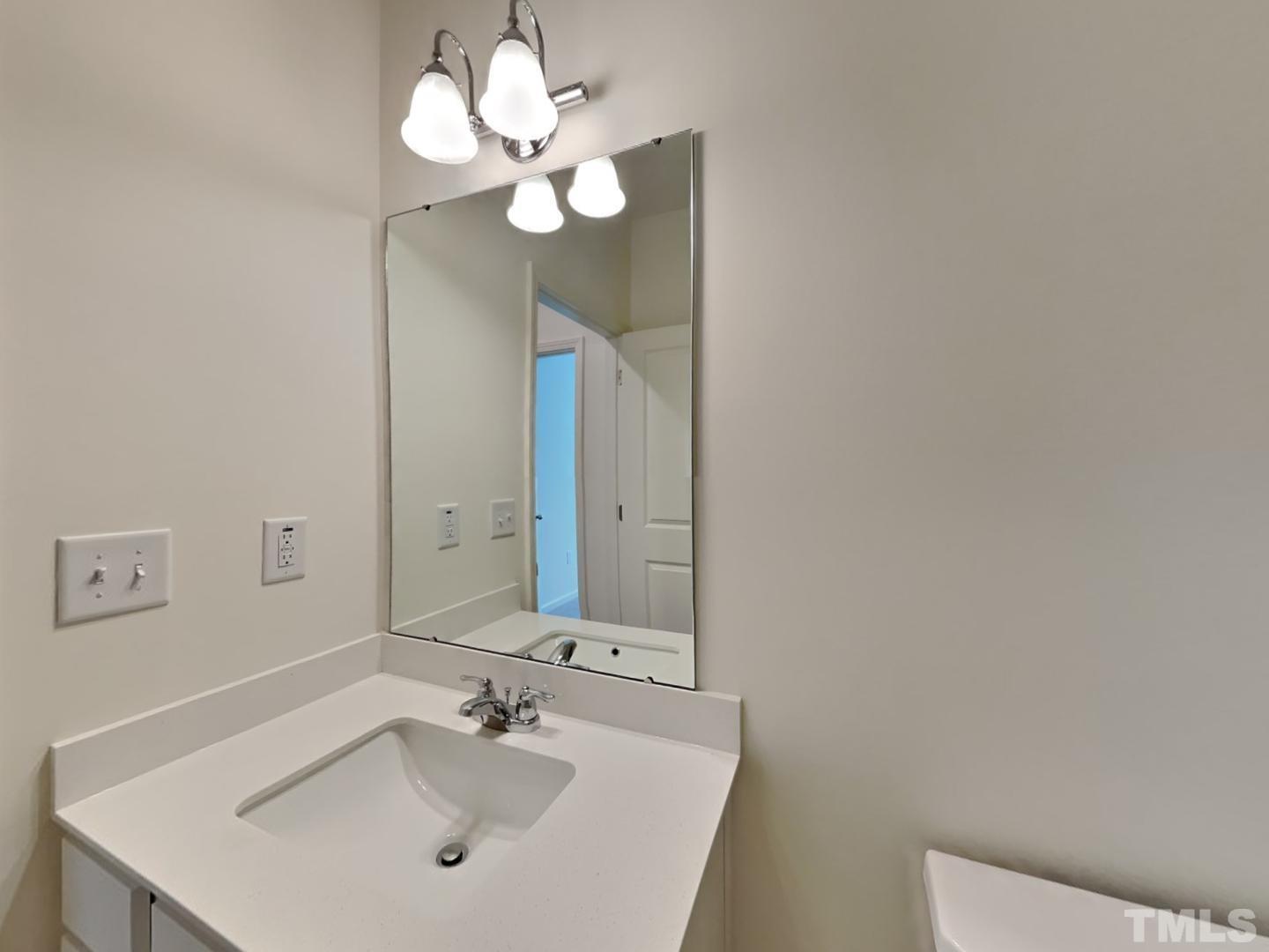117 Mdw Vista Lane Angier, NC 27501 - Photo 15 of 18 a bathroom with a sink and a mirror