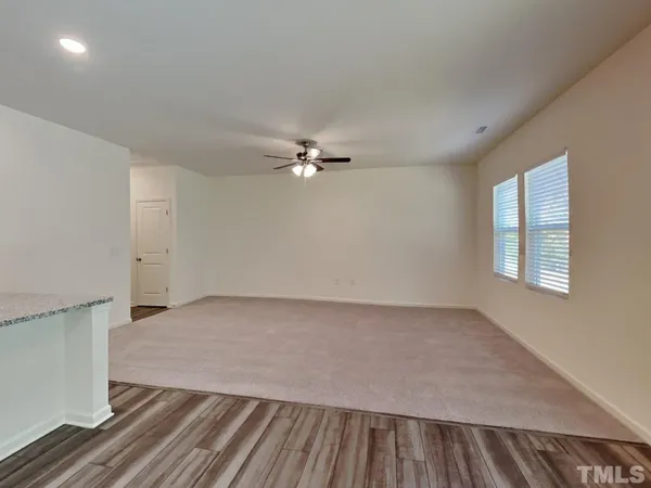 a view of a room with wooden floor and fan