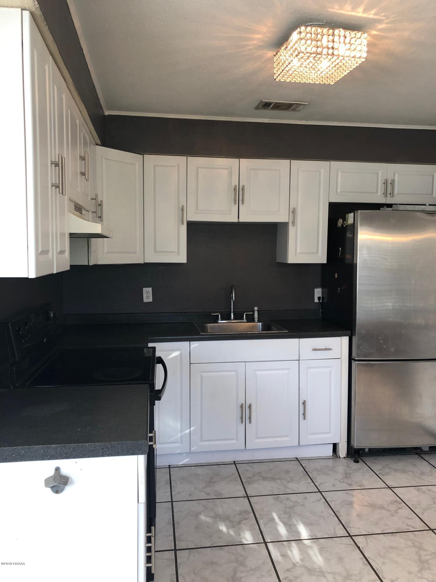1417 Constantine Street Orlando, FL 32825 - Photo 3 of 14 a kitchen with a refrigerator and a sink