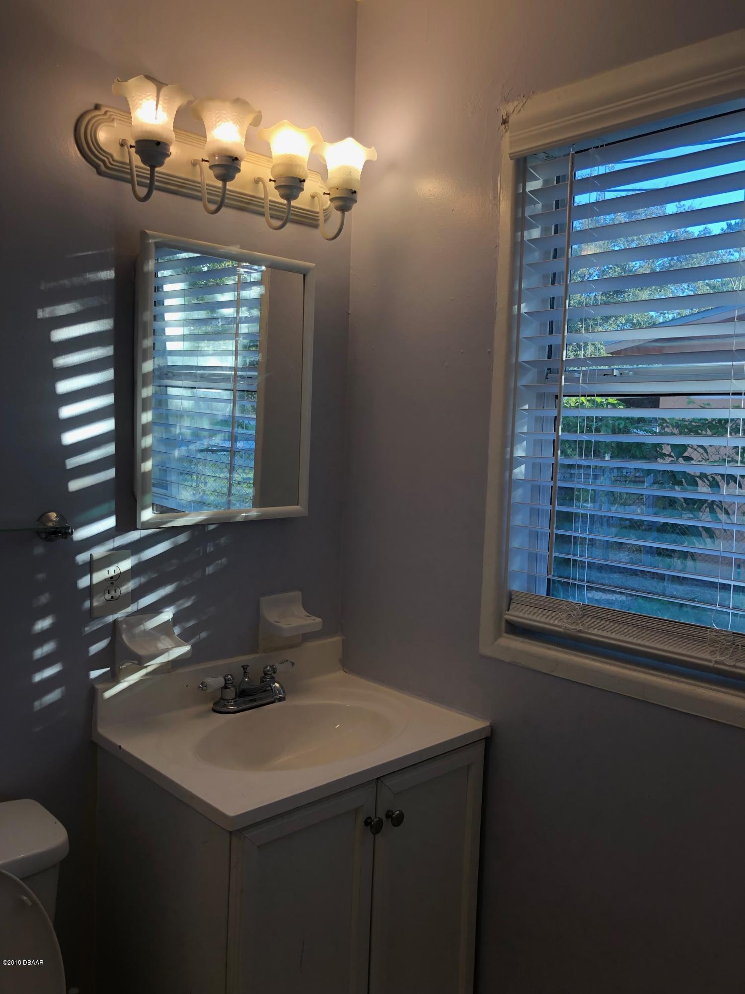 1417 Constantine Street Orlando, FL 32825 - Photo 5 of 14 a bathroom with a sink and a mirror
