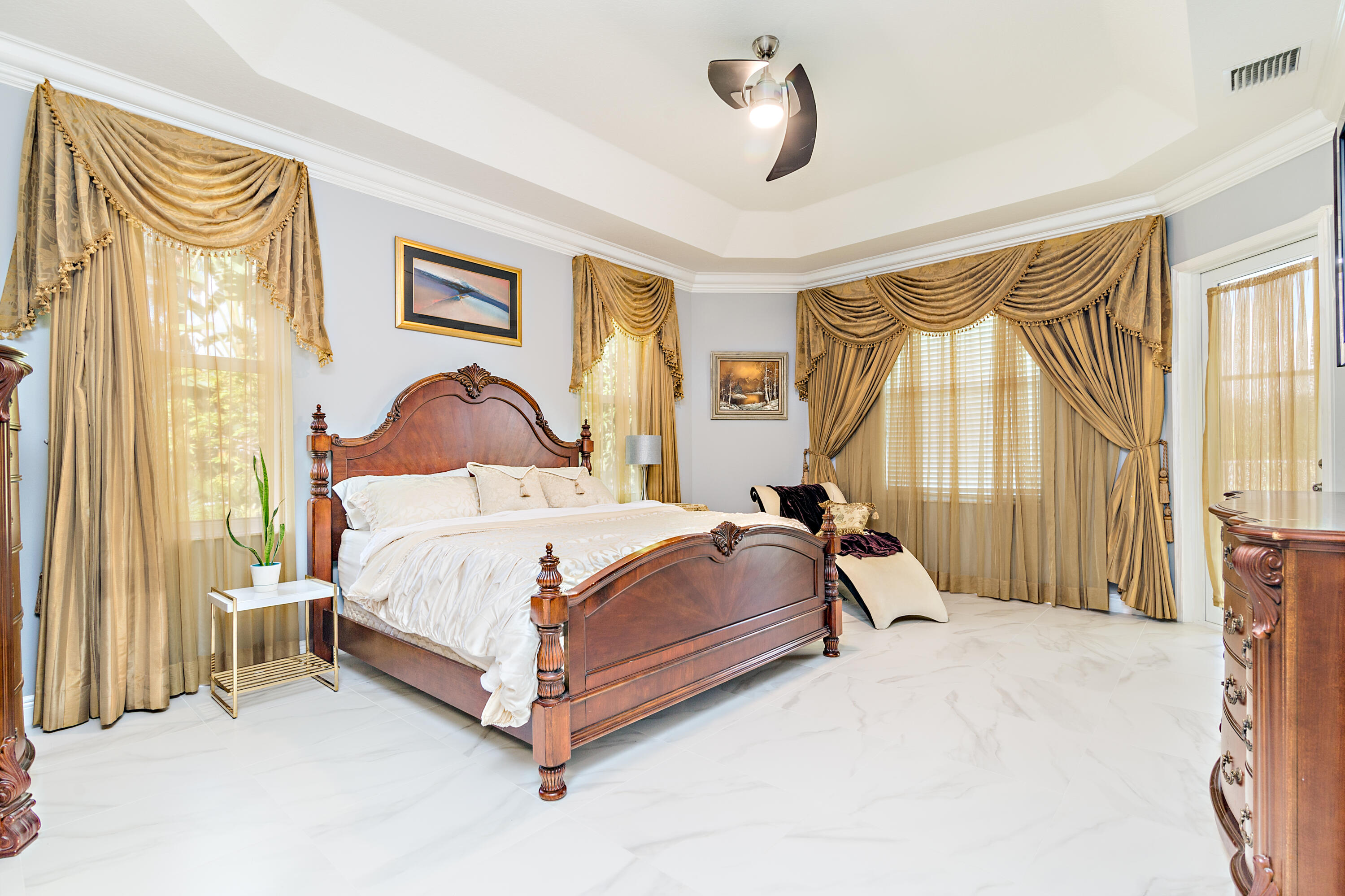 6813 Wilson Road West Palm Beach, FL 33413 - Photo 14 of 26 a bedroom with a bed lamp and a large window