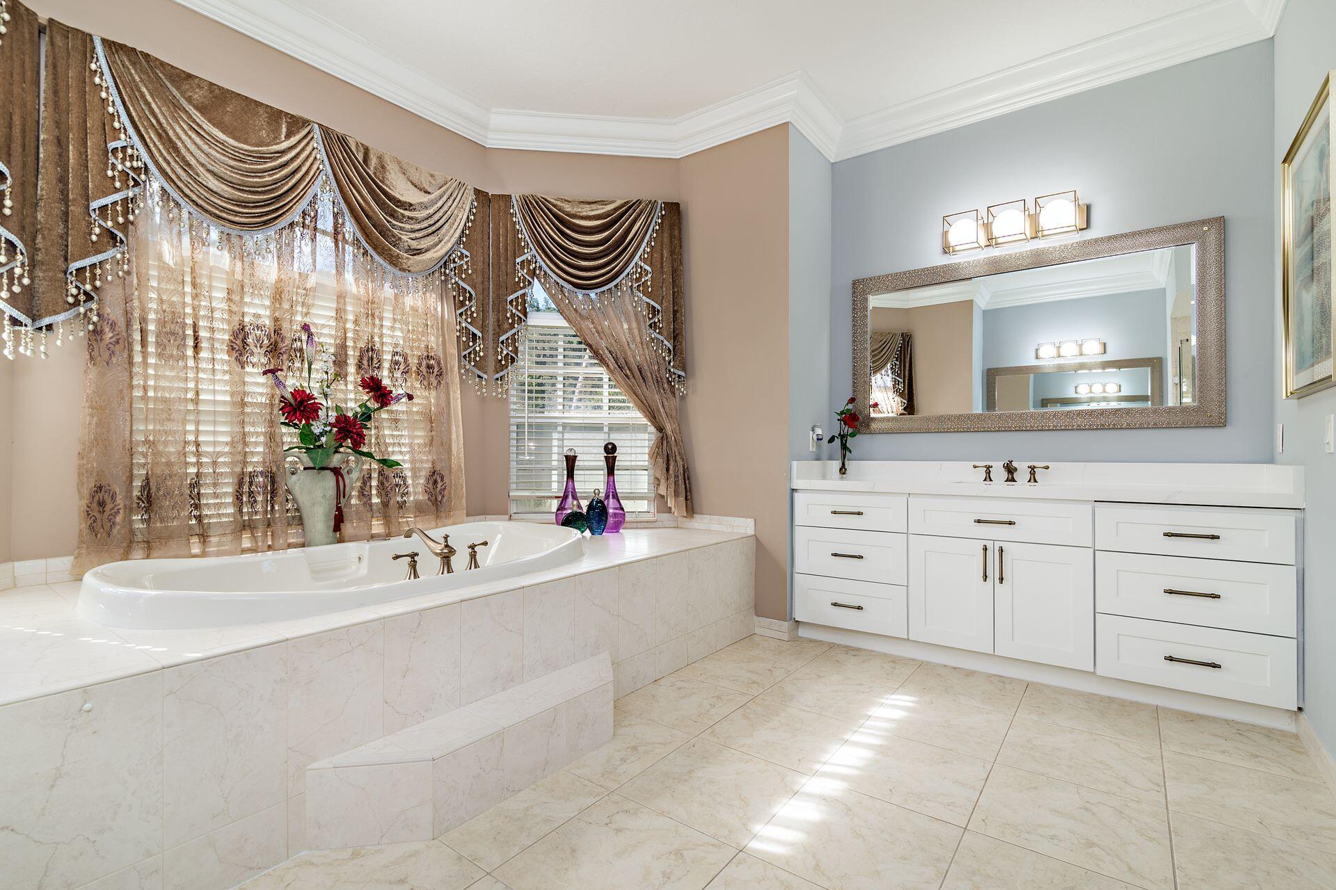 6813 Wilson Road West Palm Beach, FL 33413 - Photo 15 of 26 a spacious bathroom with a sink and a mirror