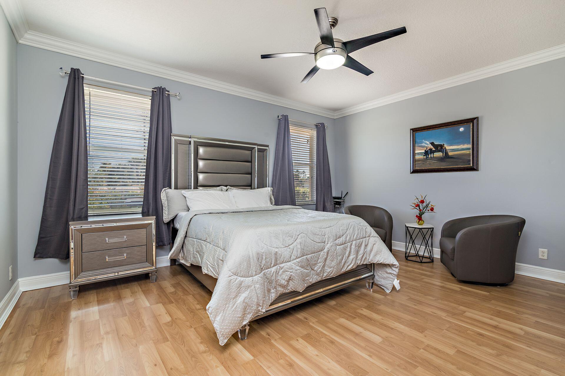 6813 Wilson Road West Palm Beach, FL 33413 - Photo 17 of 26 a bedroom with a bed and a chair