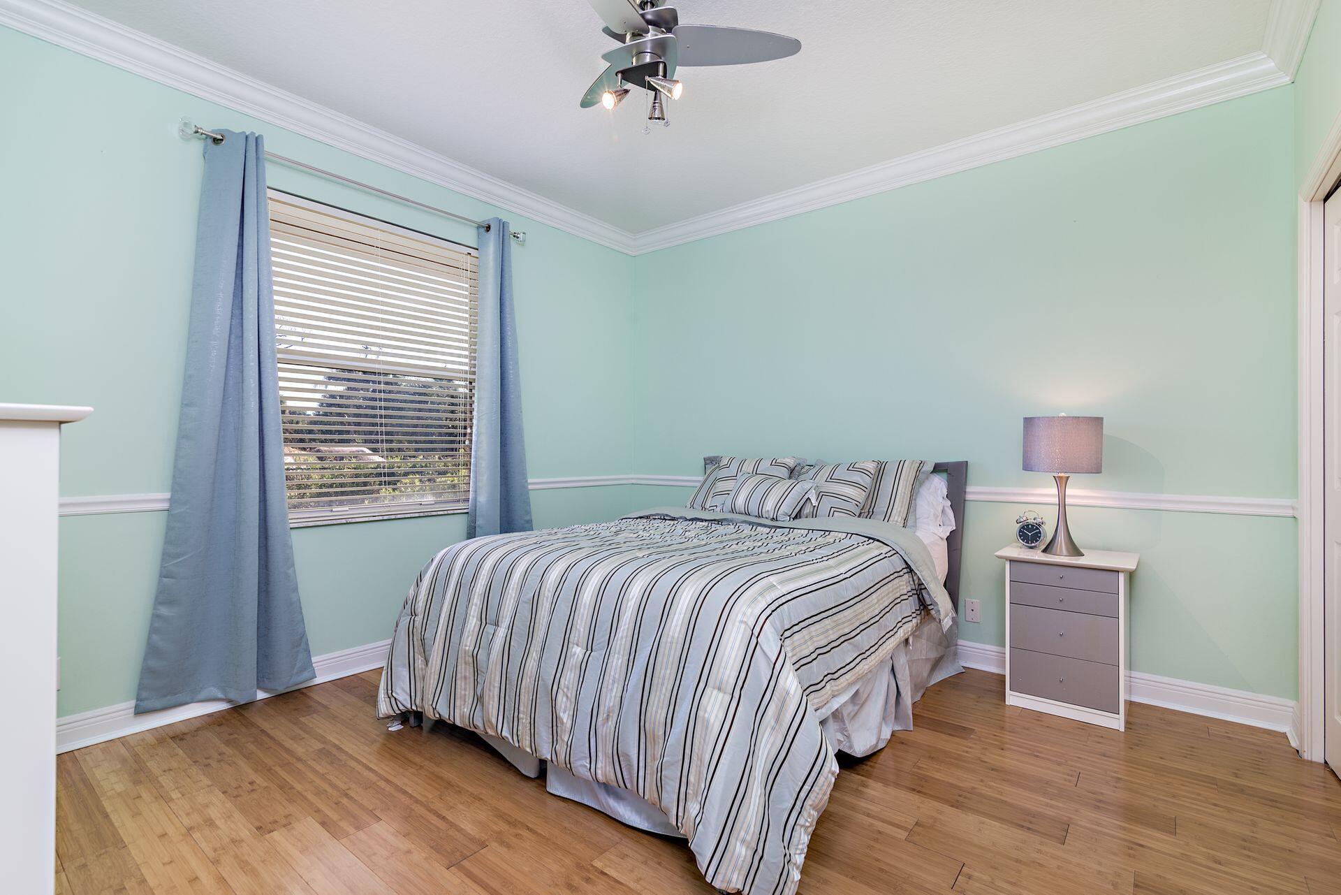 6813 Wilson Road West Palm Beach, FL 33413 - Photo 19 of 26 a bedroom with a bed and a window