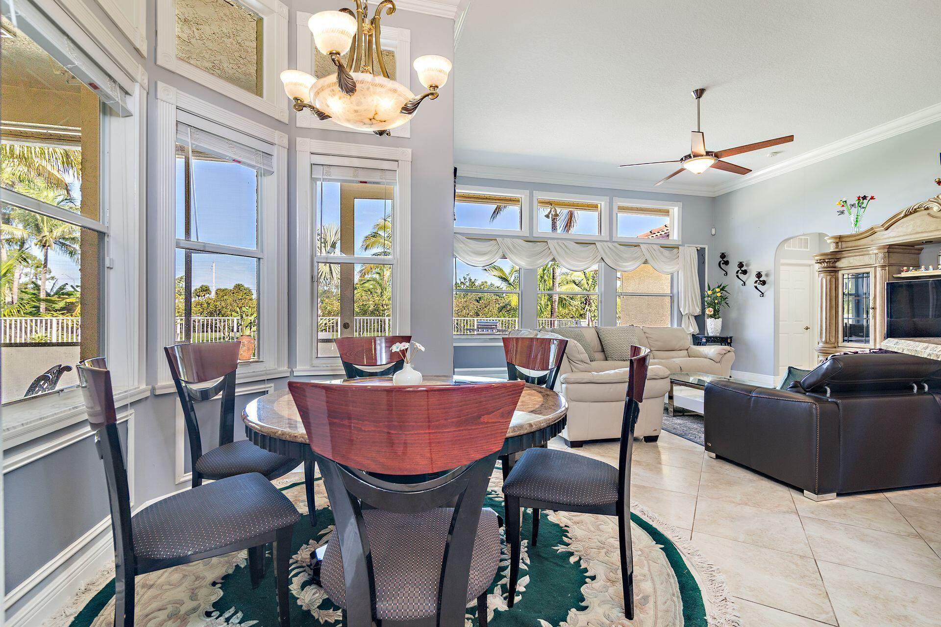 6813 Wilson Road West Palm Beach, FL 33413 - Photo 9 of 26 a dining room with furniture a chandelier and a rug