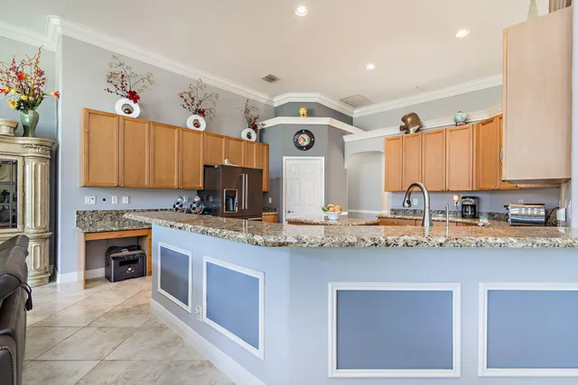 a kitchen with stainless steel appliances granite countertop a sink and cabinets
