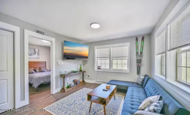 a living room with furniture and a wooden floor