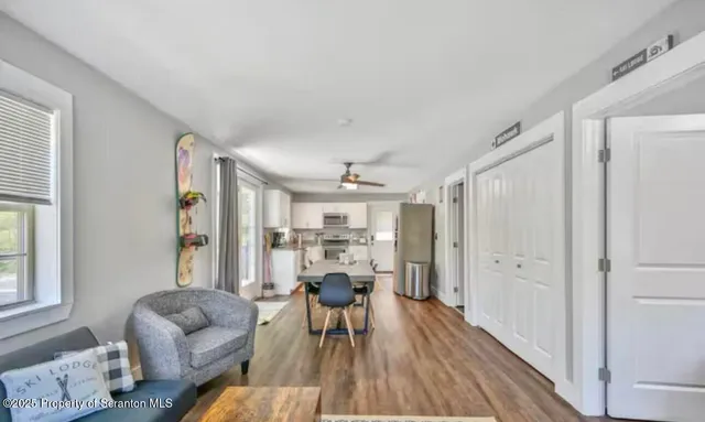 a view of a dining room with furniture window and wooden floor