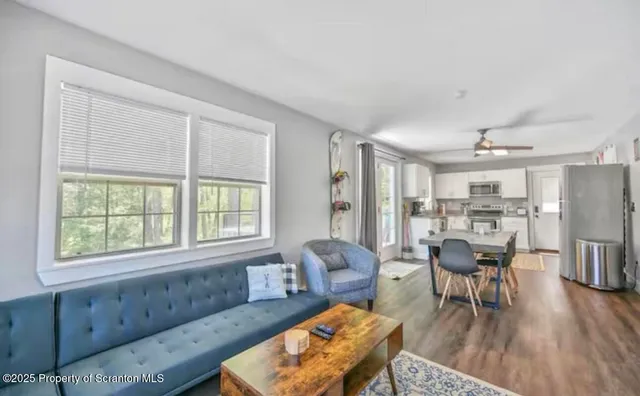 a living room with furniture and a large window