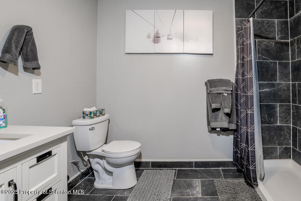 4562 Highway 374 Nicholson, PA 18446 - Photo 25 of 38 a bathroom with a toilet and a shower