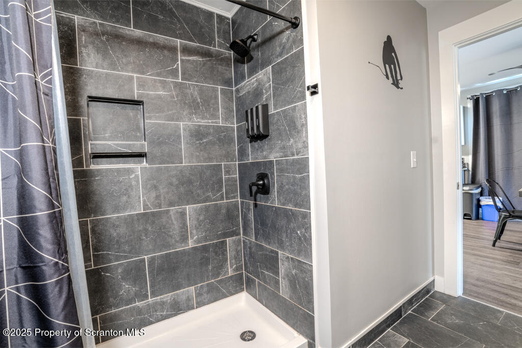 4562 Highway 374 Nicholson, PA 18446 - Photo 26 of 38 a bathroom with a glass shower door