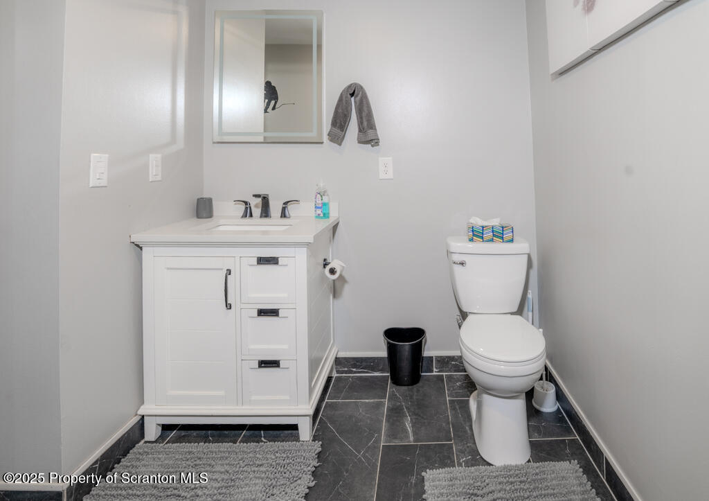 4562 Highway 374 Nicholson, PA 18446 - Photo 27 of 38 a bathroom with a sink toilet and vanity