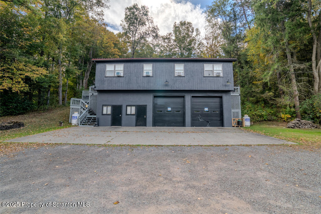 4562 Highway 374 Nicholson, PA 18446 - Photo 3 of 38 a front view of a house with a yard and garage